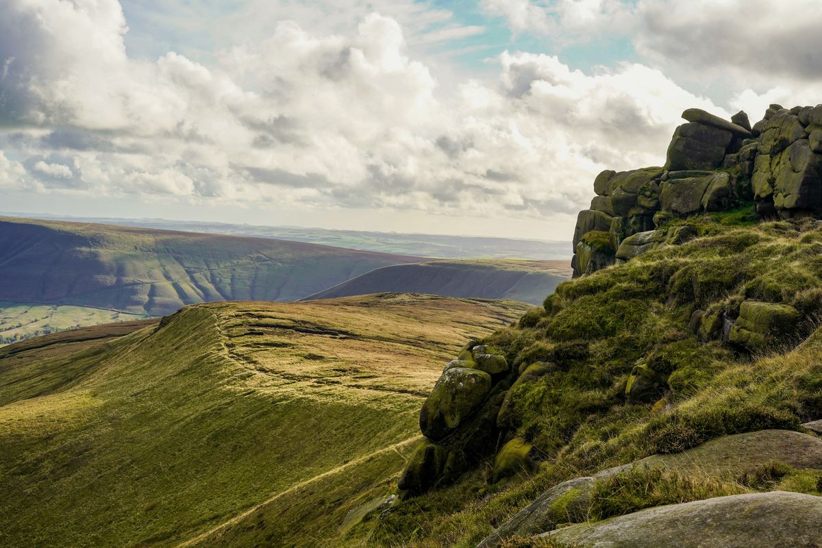 A gritstone outcrop on Kinder Scout looking over the Vale of Edale